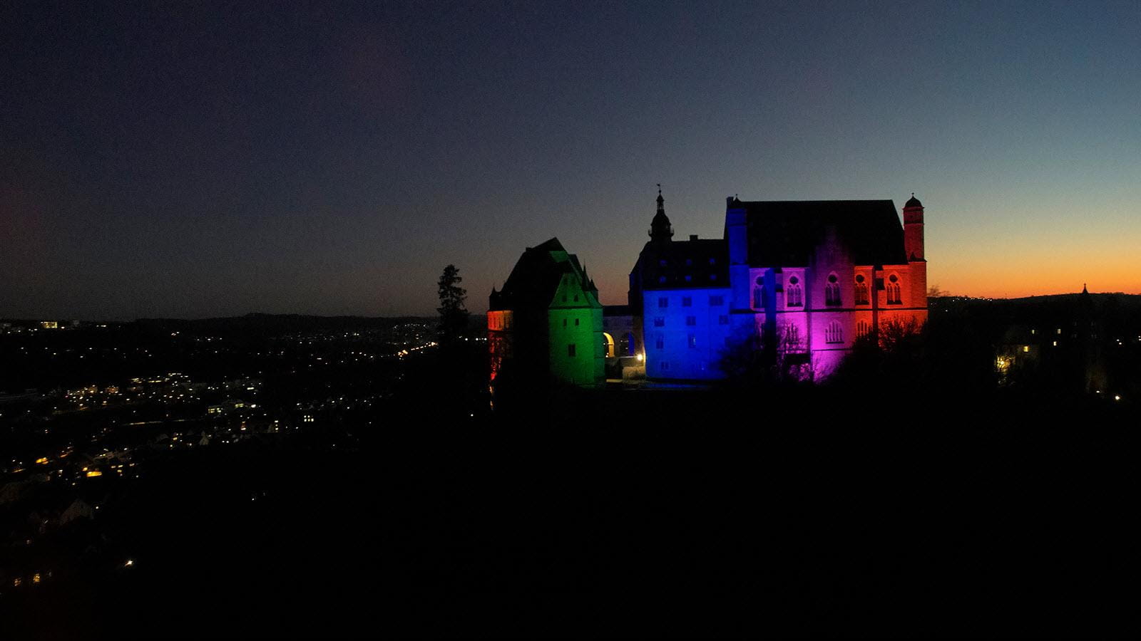 Marburg Castle lit up in the colors of Rare Disease Day.